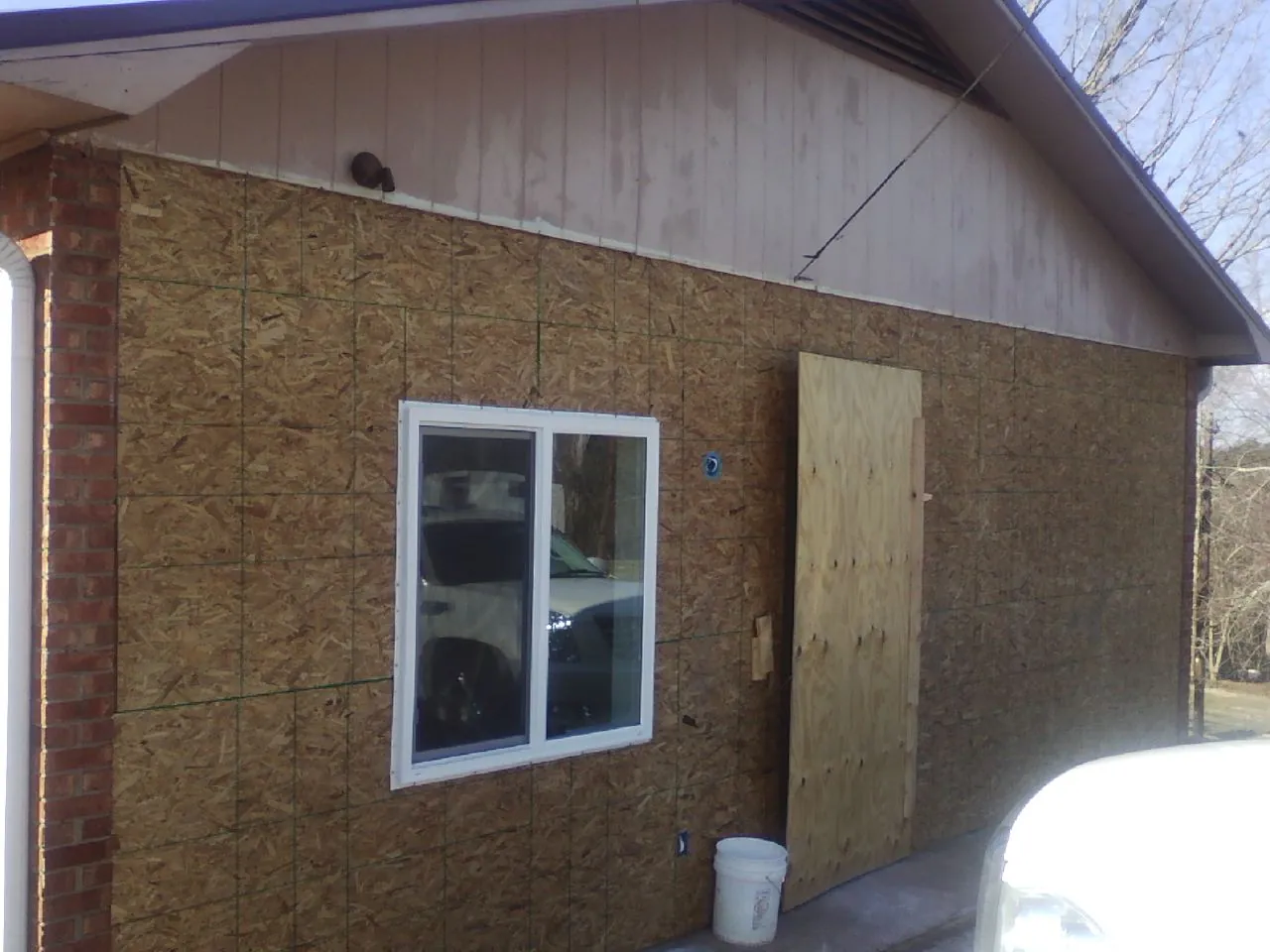 OSB sheathing on a garage addition wall before siding in Scottsburg