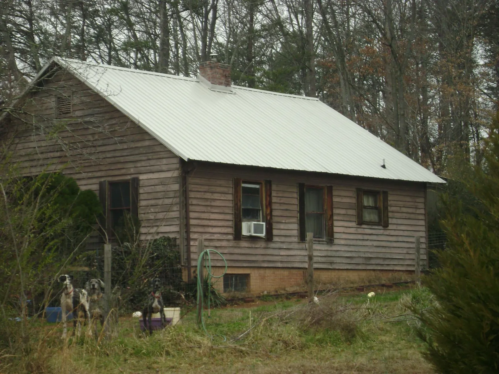 White metal roof on an old wood sided farmhouse, from a Metal Roof Installation job in Scottsburg